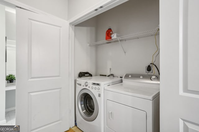 washroom with washing machine and clothes dryer