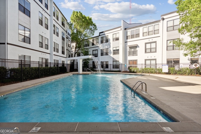 view of swimming pool with pool water feature