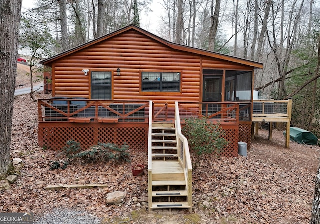 back of house featuring a sunroom and a deck