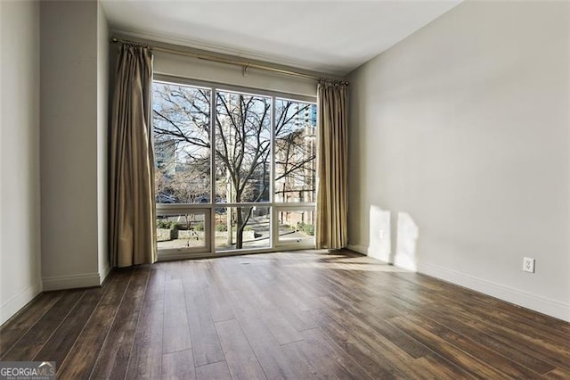 empty room with dark hardwood / wood-style floors