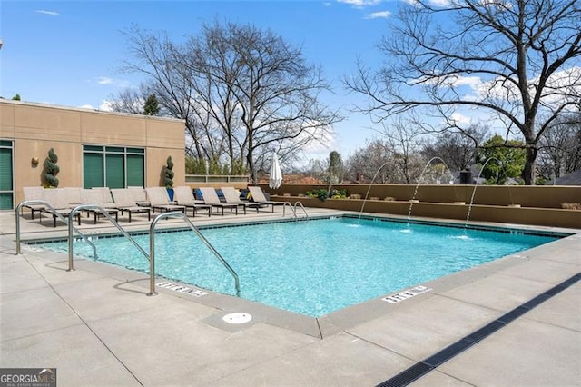 view of pool featuring pool water feature and a patio