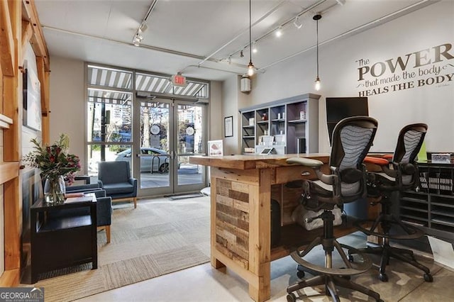 interior space featuring french doors, rail lighting, and hanging light fixtures