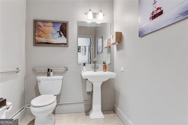 bathroom featuring tile patterned flooring and toilet