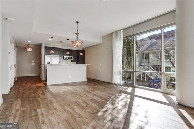 unfurnished living room with dark hardwood / wood-style flooring