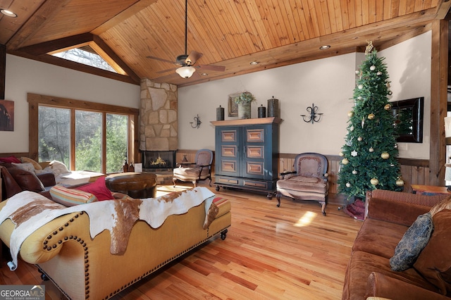 living room with wood ceiling, ceiling fan, hardwood / wood-style flooring, a fireplace, and lofted ceiling