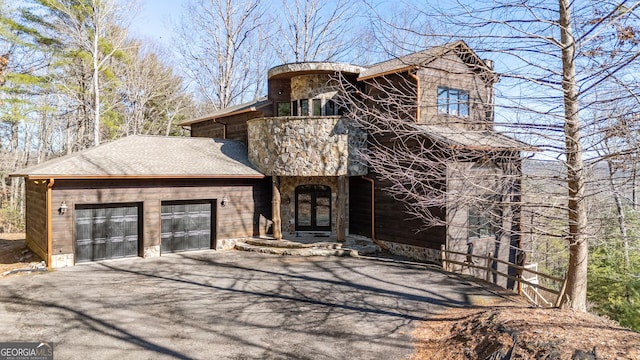 view of front of home with a garage and french doors