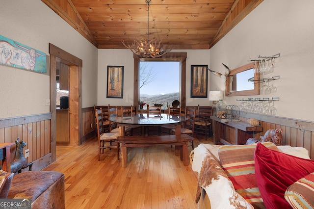 dining space featuring a healthy amount of sunlight, wooden ceiling, vaulted ceiling, and light wood-type flooring