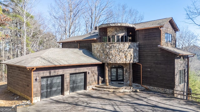 view of front of house with a balcony and a garage