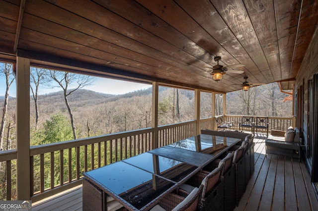 wooden deck featuring ceiling fan