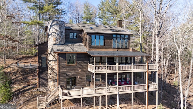 rear view of property featuring a balcony