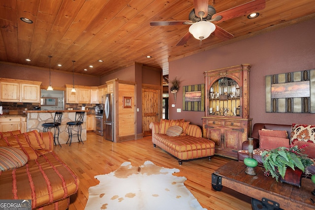 living room featuring wood ceiling, ceiling fan, and light hardwood / wood-style floors