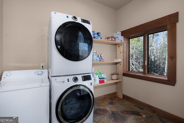 clothes washing area featuring stacked washer and dryer