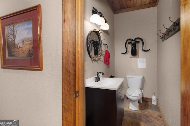 bathroom featuring vanity, wooden ceiling, and toilet