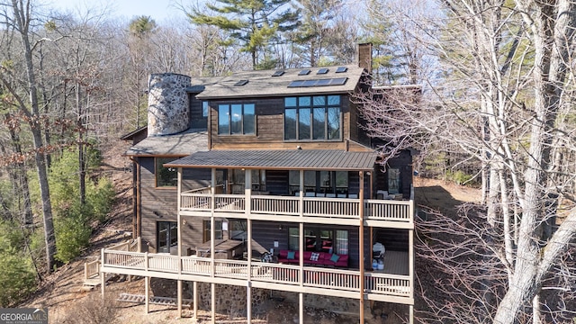 back of house featuring a balcony