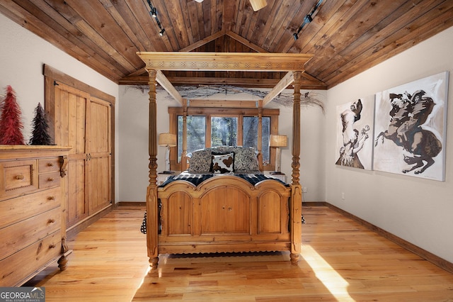 bedroom featuring track lighting, ornate columns, wood ceiling, light hardwood / wood-style flooring, and lofted ceiling