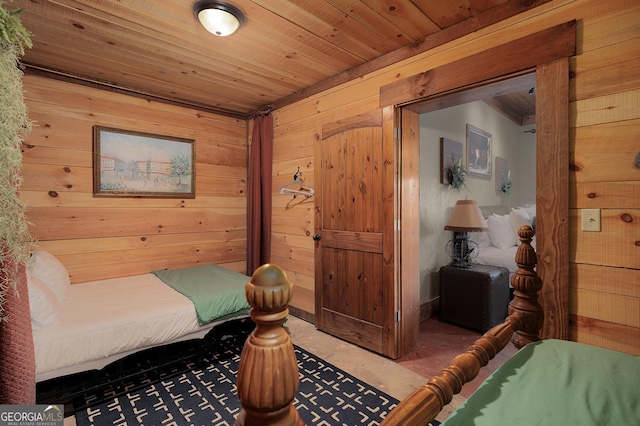 bedroom with wood walls and wooden ceiling