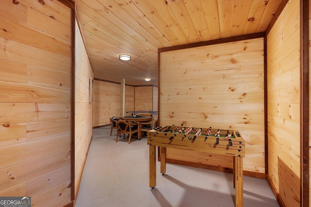 recreation room featuring wood walls and wooden ceiling