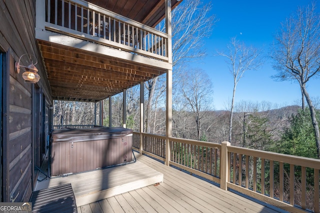 wooden terrace featuring a hot tub