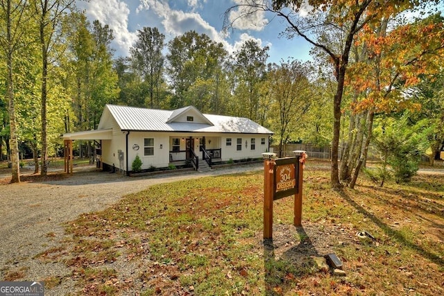 view of front of property featuring a porch and a carport