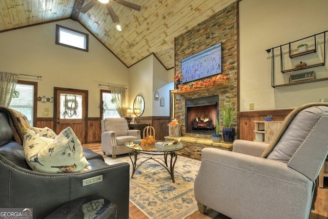 living room with wooden ceiling, high vaulted ceiling, ceiling fan, a fireplace, and wood-type flooring