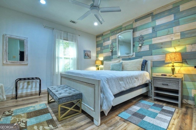 bedroom with ceiling fan and wood-type flooring