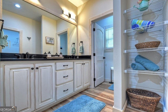 bathroom with hardwood / wood-style floors and vanity