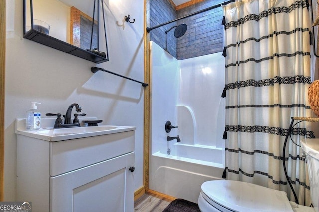 full bathroom featuring hardwood / wood-style flooring, vanity, toilet, and shower / tub combo