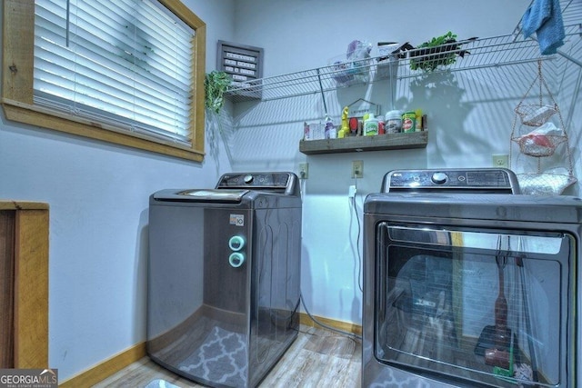 laundry room with independent washer and dryer and hardwood / wood-style floors