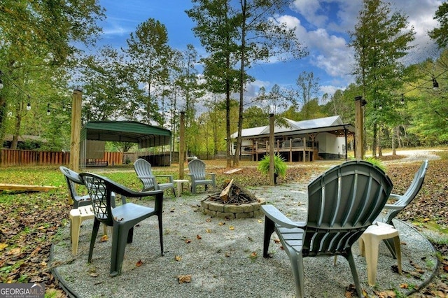 surrounding community with a fire pit and a deck