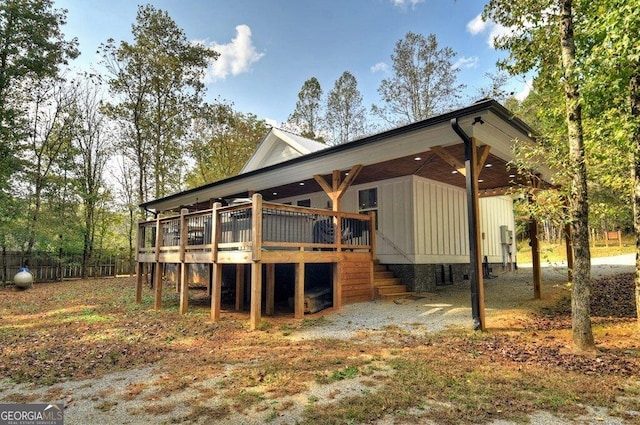 rear view of property featuring a deck