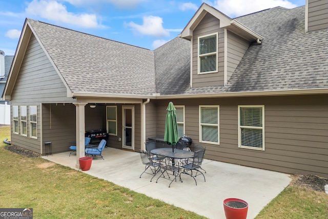 back of house featuring a yard and a patio