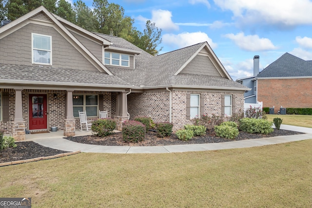 craftsman-style home with covered porch and a front lawn