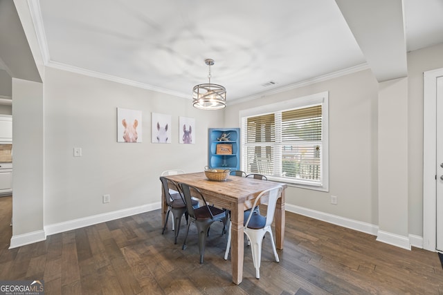 dining area featuring dark hardwood / wood-style floors, an inviting chandelier, and ornamental molding