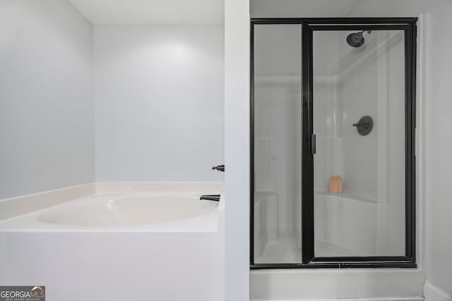 bathroom with separate shower and tub