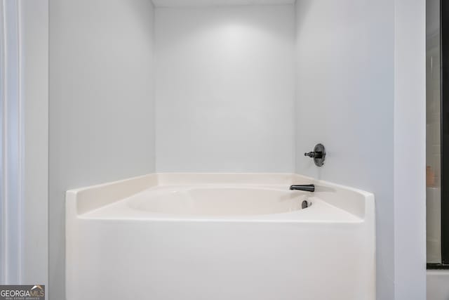 bathroom featuring a tub to relax in