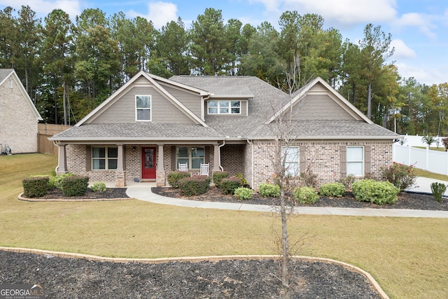 craftsman-style house with covered porch and a front yard