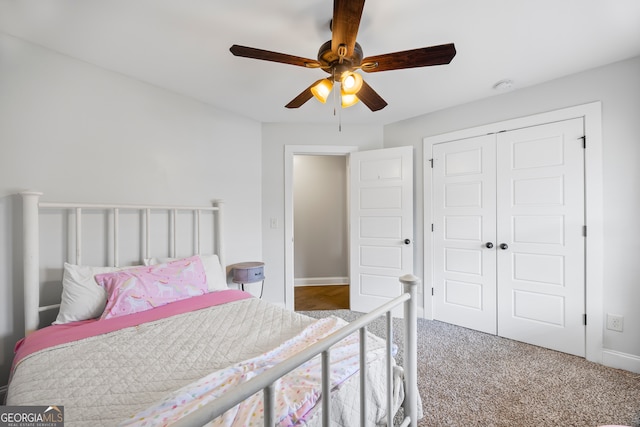 carpeted bedroom featuring ceiling fan and a closet