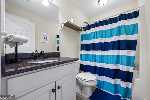 bathroom featuring walk in shower, vanity, and toilet