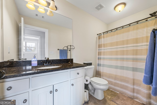 bathroom with vanity and toilet