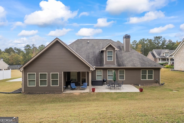 back of house with a patio area and a yard