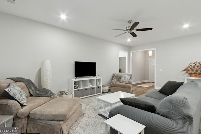 living room with ceiling fan and wood-type flooring