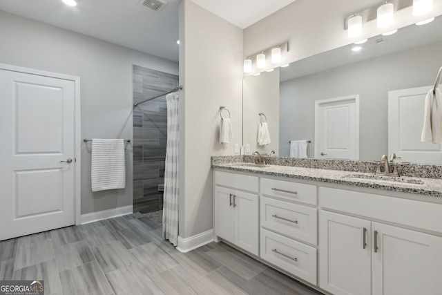 bathroom featuring a shower with curtain and vanity