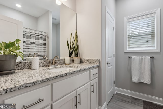 bathroom featuring vanity and curtained shower