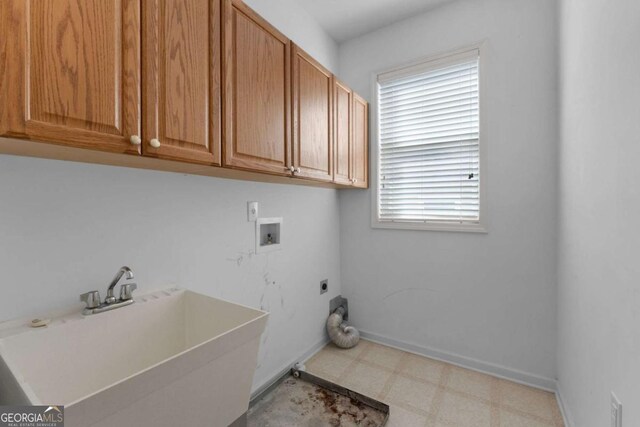 laundry area featuring hookup for a washing machine, tile patterned floors, a sink, electric dryer hookup, and cabinet space