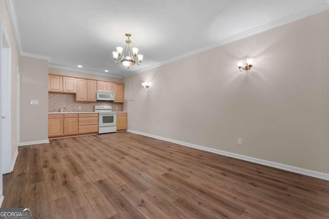 kitchen with white appliances, wood finished floors, tasteful backsplash, light brown cabinets, and an inviting chandelier