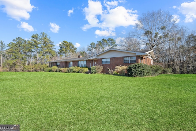 ranch-style home featuring a front yard