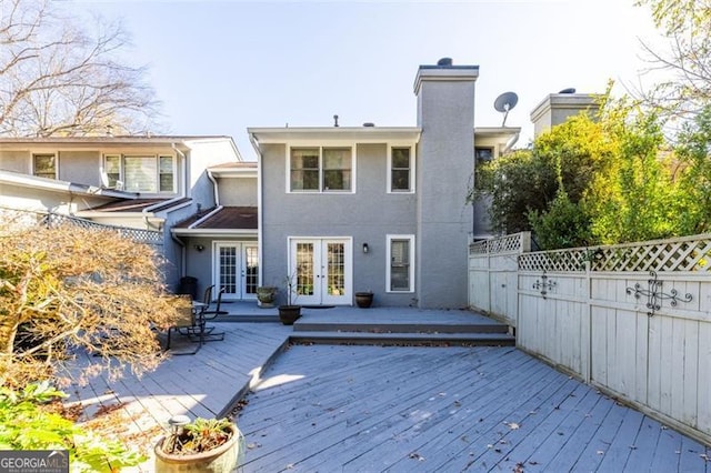 rear view of house with french doors and a deck