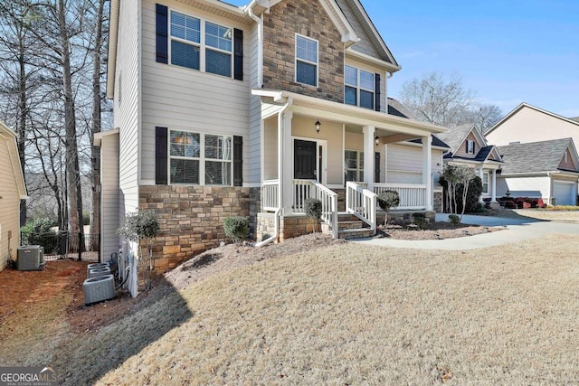 view of front facade with a front lawn, cooling unit, and covered porch