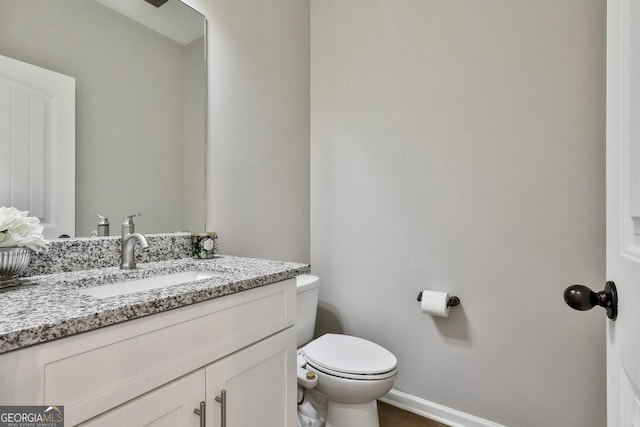 bathroom featuring vanity and toilet