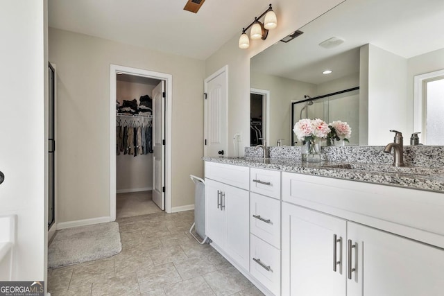 bathroom featuring vanity and a shower with shower door